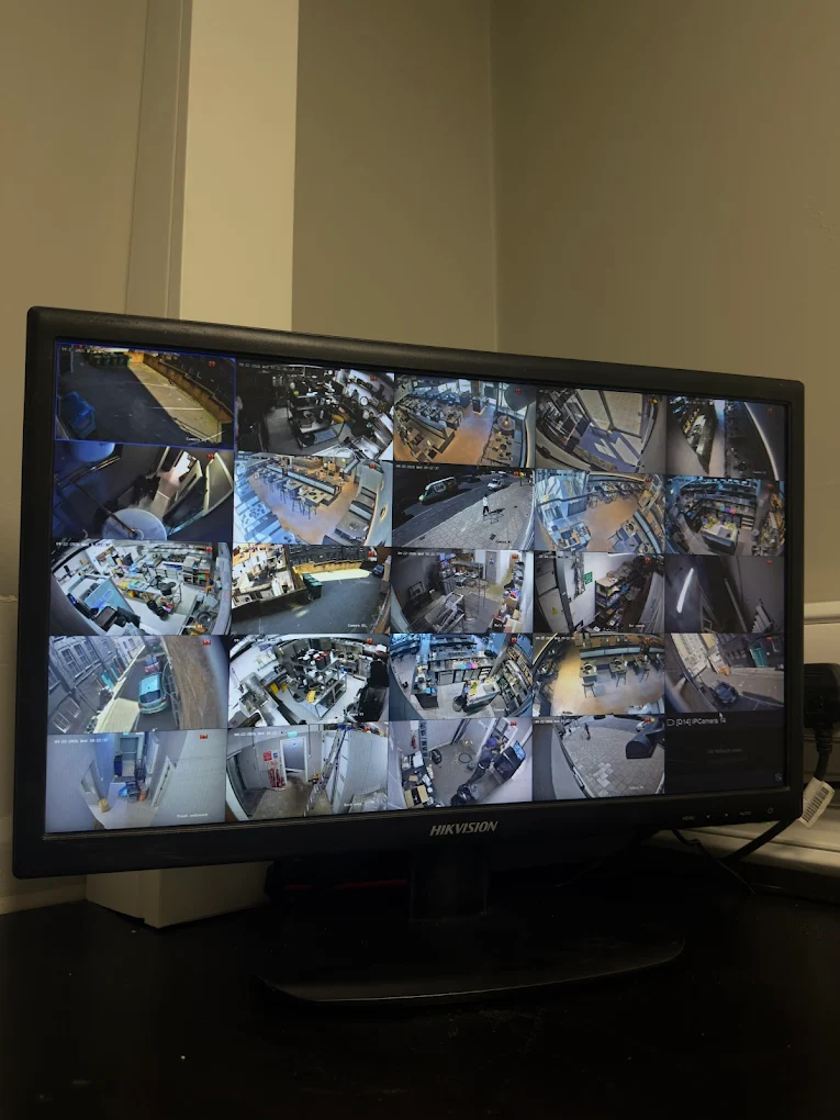 Hikvision 16-channel CCTV monitor showing all camera feeds, Bristol