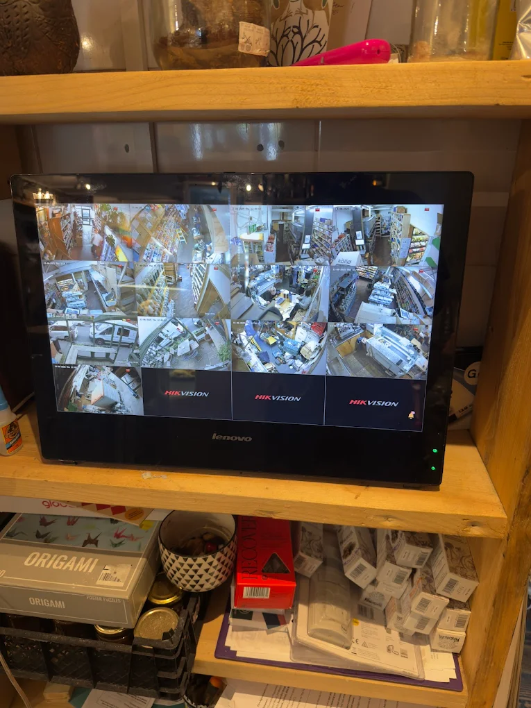 Hikvision CCTV monitor showing live shop camera feeds, Bristol retail