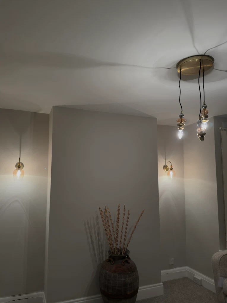 Decorative ceiling light cluster with matching wall sconces installed in Bristol home
