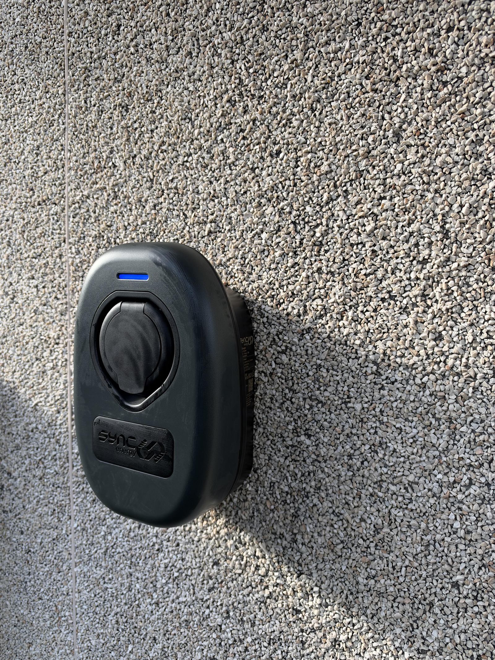 Sync Energy EV charger installed on a pebbledash wall in Bristol