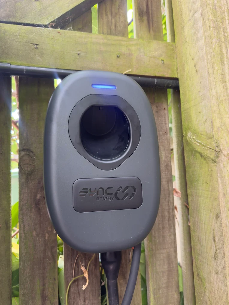 Sync Energy EV charger installed on wooden fence pergola in Bristol garden