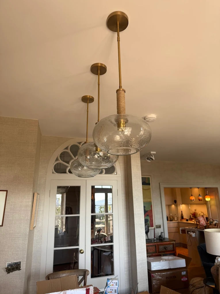 Brass and glass globe pendant lights installed in a Bristol living room