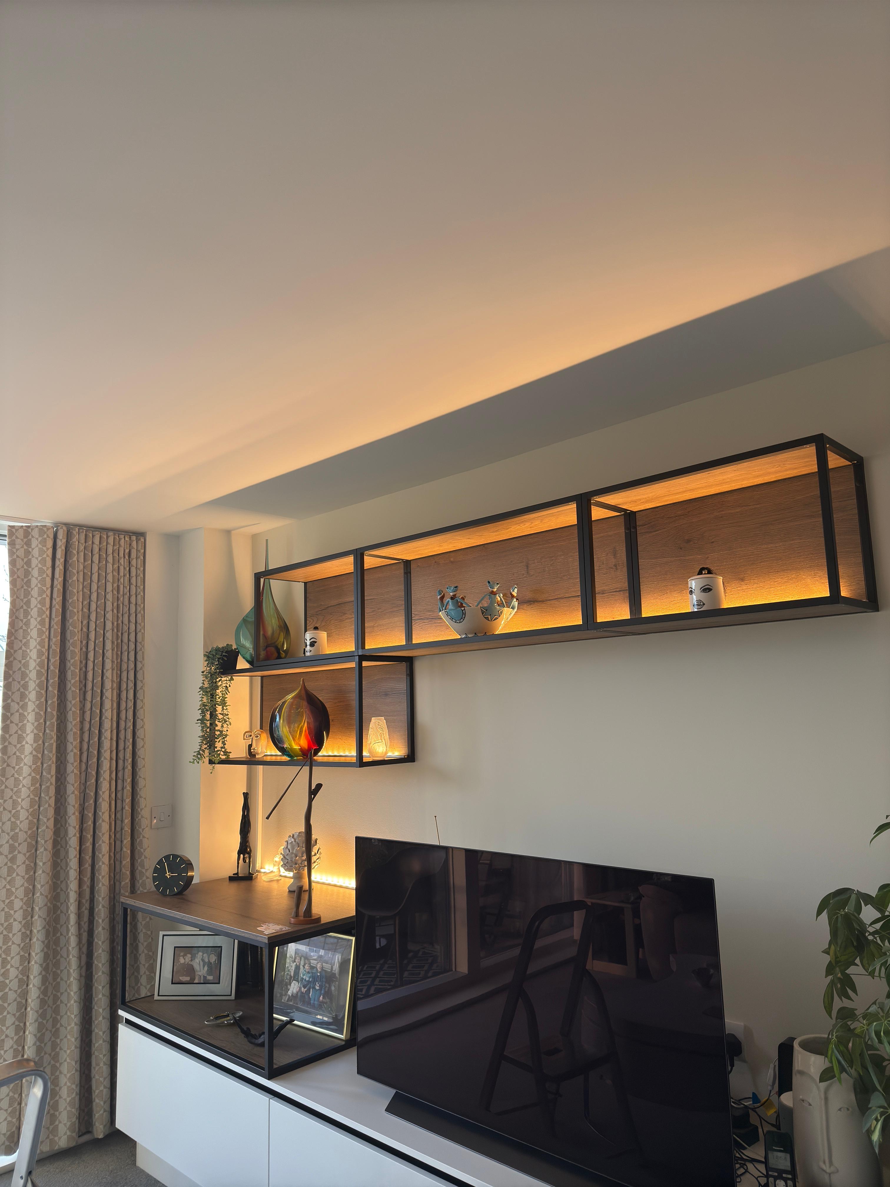 LED strip lighting inside a living room shelving unit, Bristol