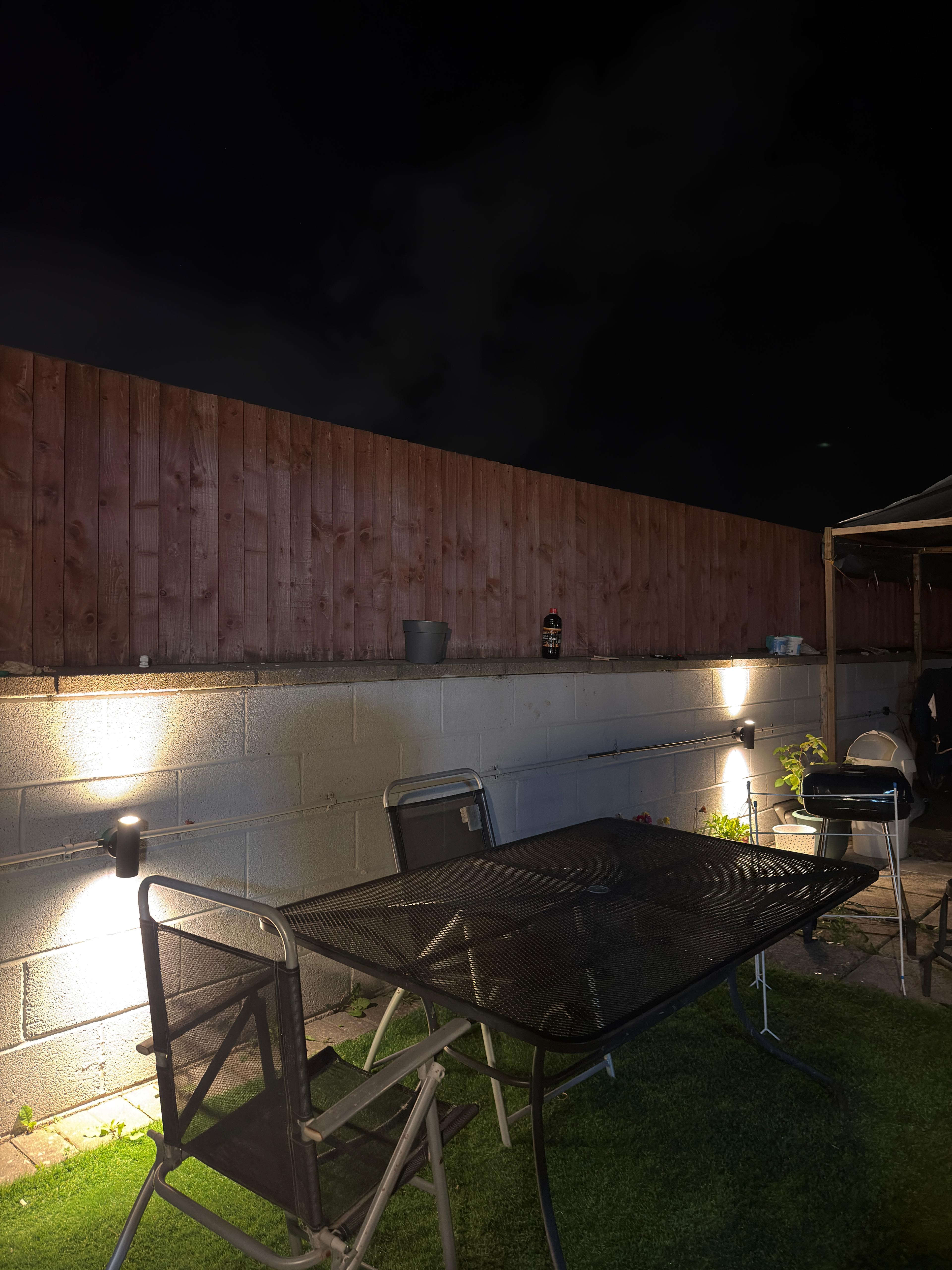 Garden wall uplights illuminating a Bristol back garden at night