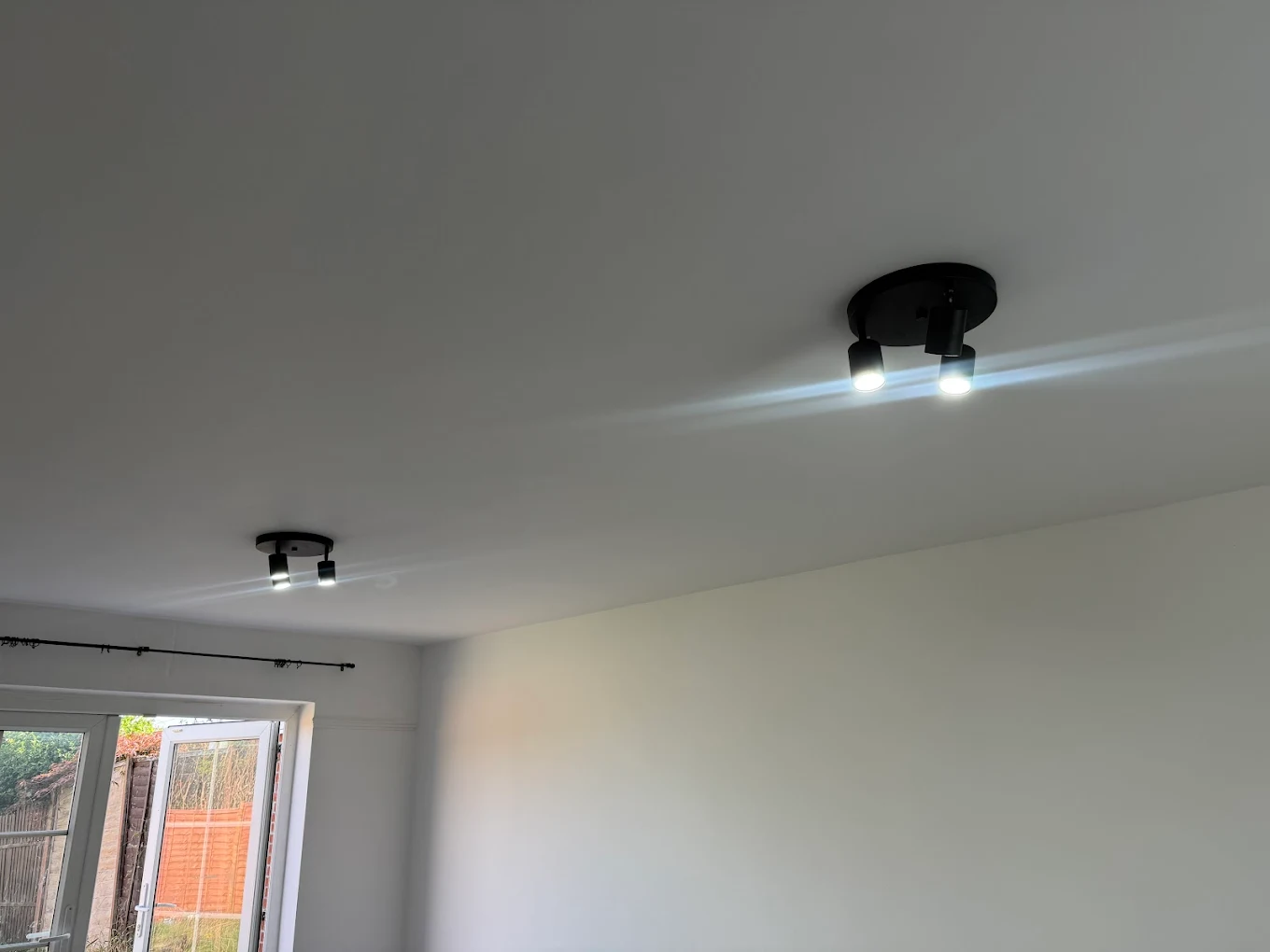 Black twin ceiling spotlights installed in Bristol bedroom